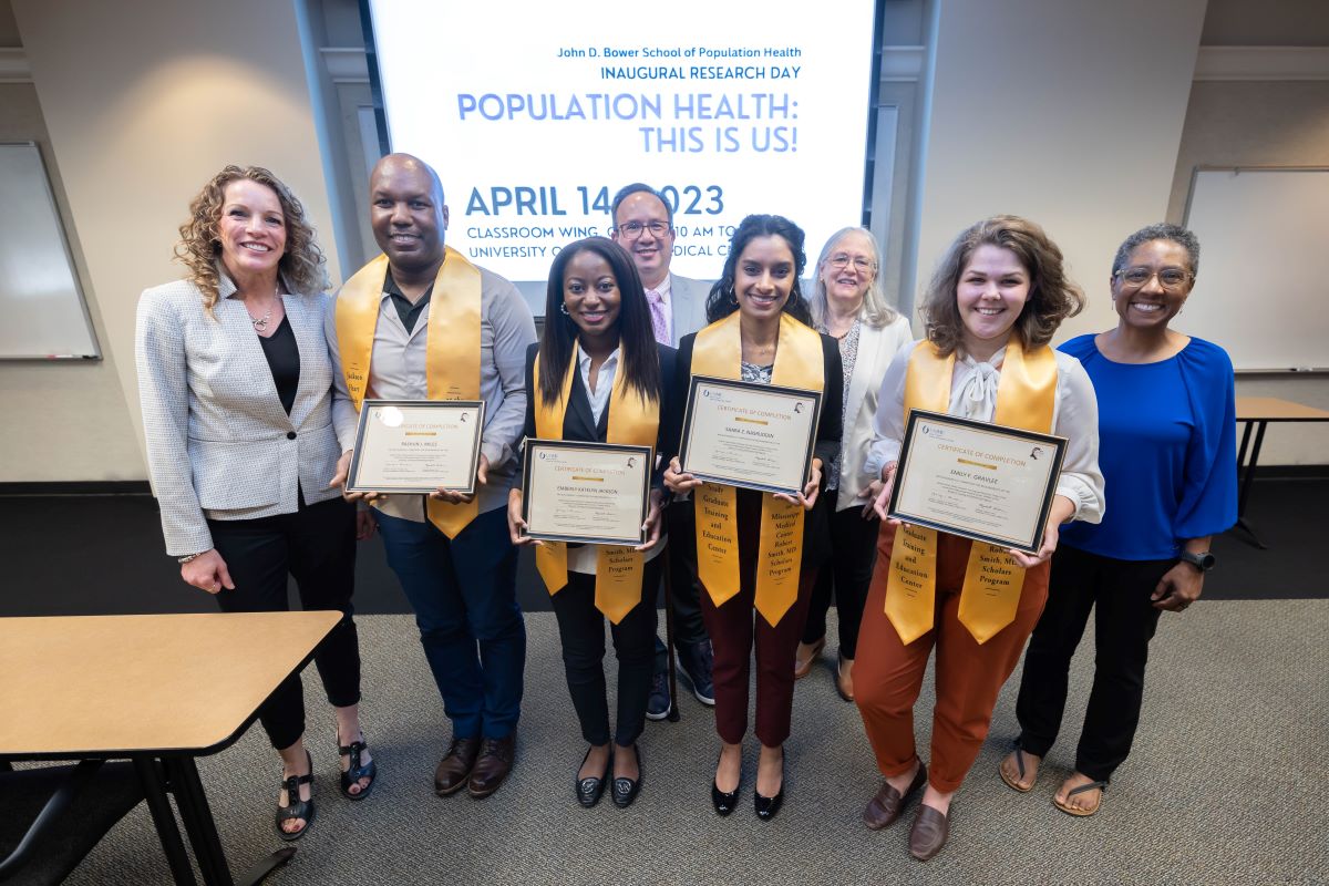 Students standing with Dr. Reneker and other team members with thier stoles and certificates at the 2023 SOPH Research Day